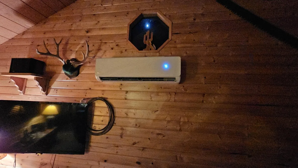 Ductless mini split indoor unit installed inside a wood cabin